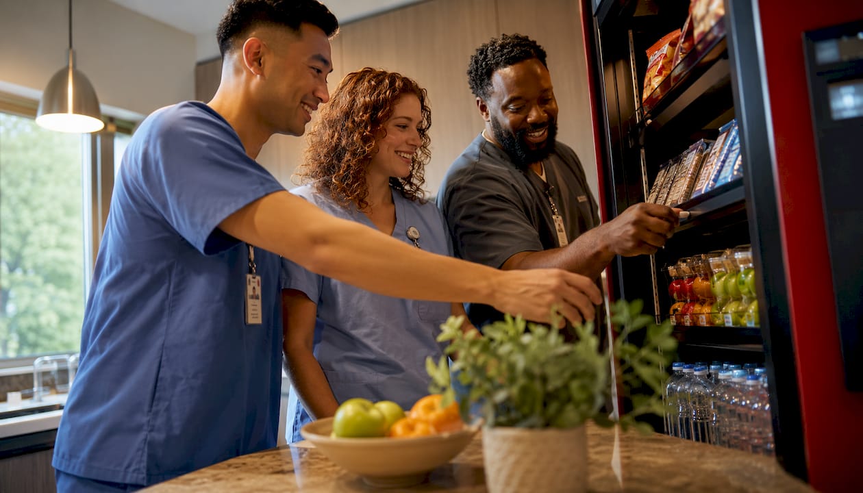 Hospital staff selecting healthy vending snacks