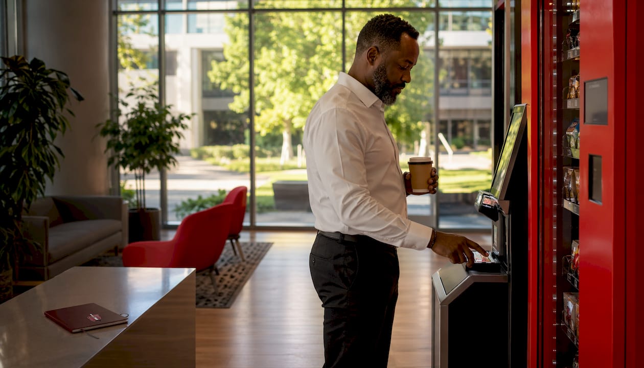 Man using self-checkout kiosk at micro-market