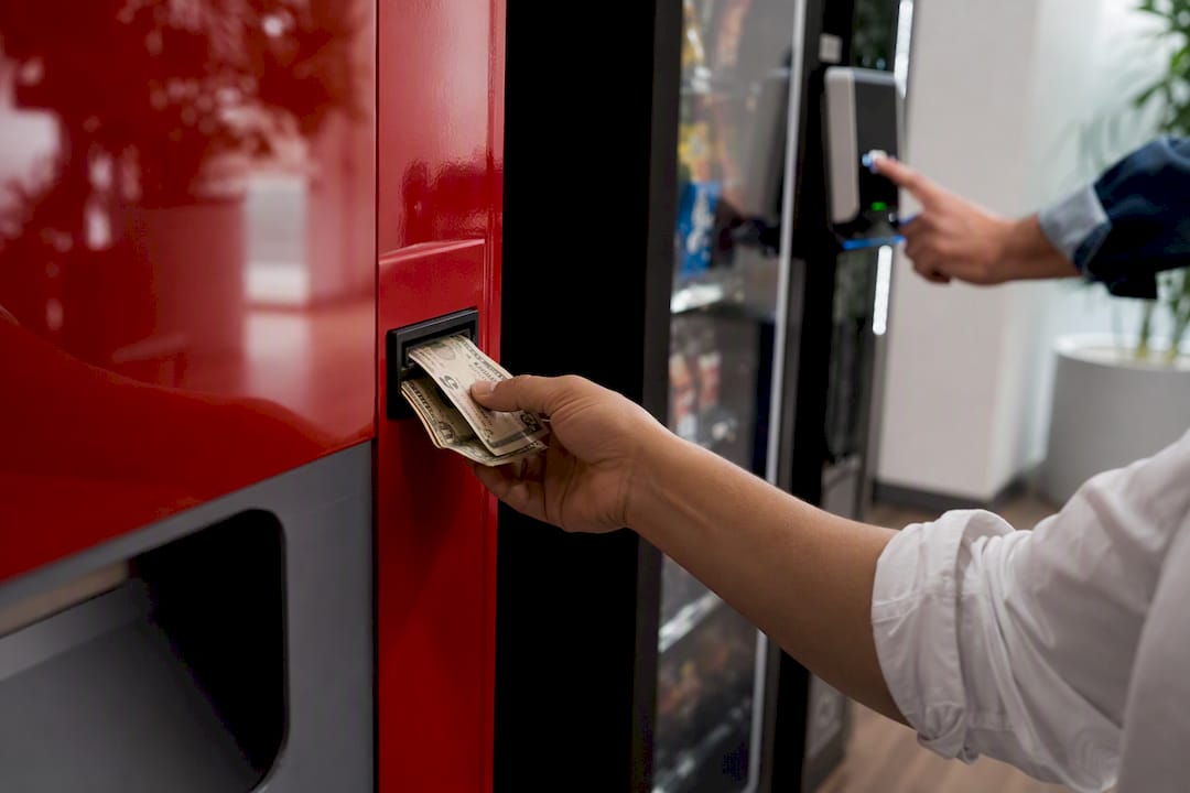 Hands using cash and card vending payment