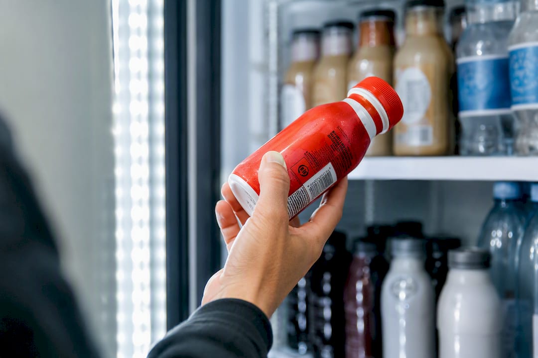 Hand checking protein drink expiry date