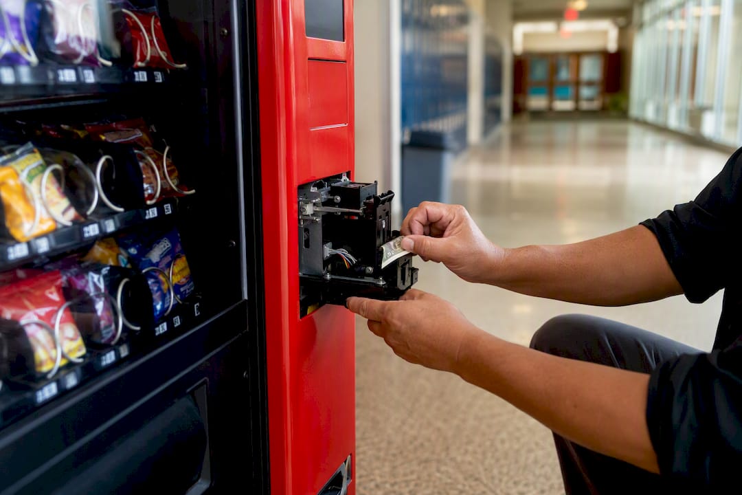 Technician hands removing jammed bill
