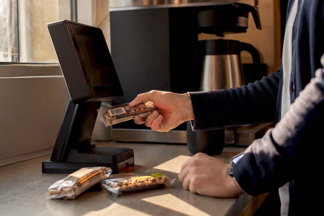 Hands scanning barcode on micro market kiosk touchscreen
